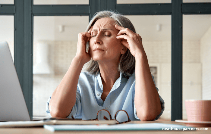 Women looking ill at work desk 