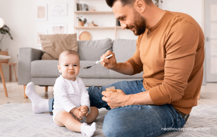 UK Father feeding a baby during paternity leave