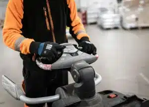A fork lift operator wearing safety gloves